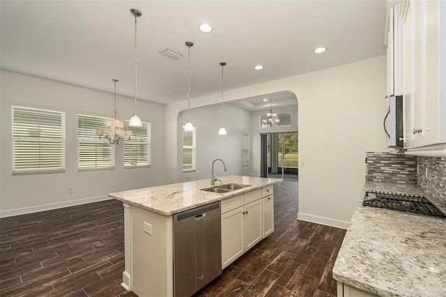 kitchen featuring light stone countertops, sink, an island with sink, and stainless steel appliances