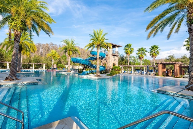 view of swimming pool with a patio area and a water slide