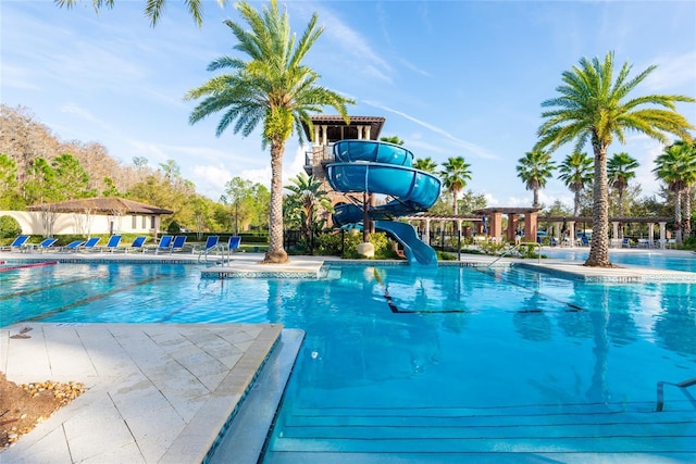 view of pool with a patio area and a water slide