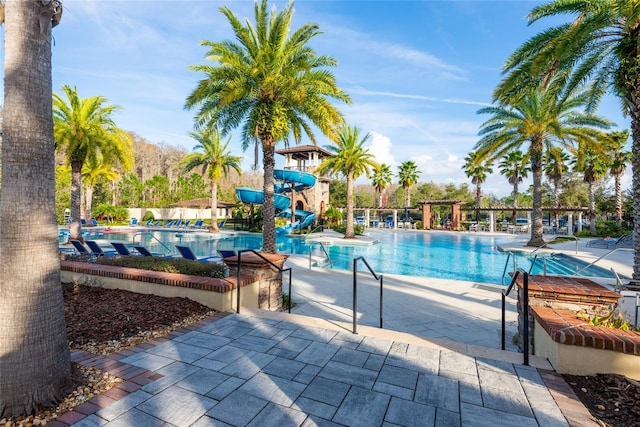 view of swimming pool featuring a patio area and a water slide