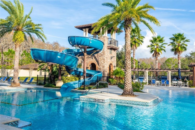 view of pool with a patio and a water slide