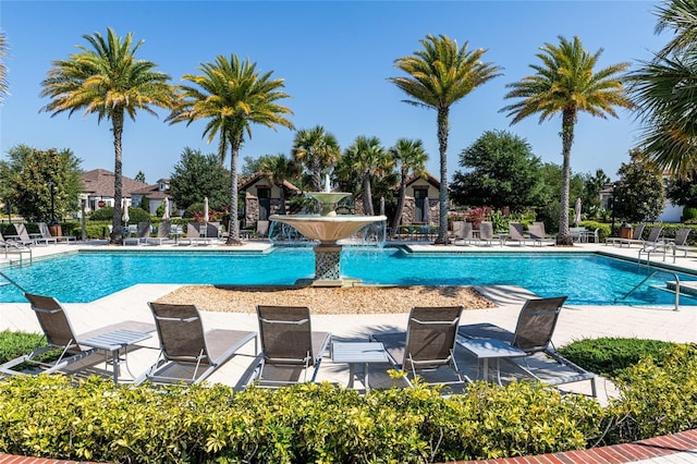 view of pool featuring pool water feature and a patio