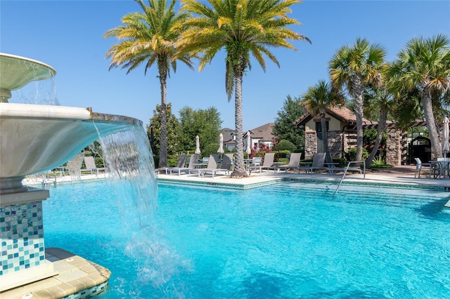 view of pool featuring pool water feature, a patio, and a water slide