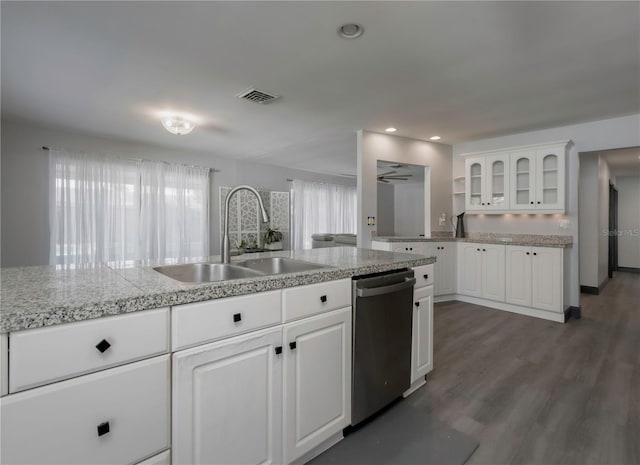 kitchen with dark hardwood / wood-style flooring, white cabinetry, stainless steel dishwasher, and sink