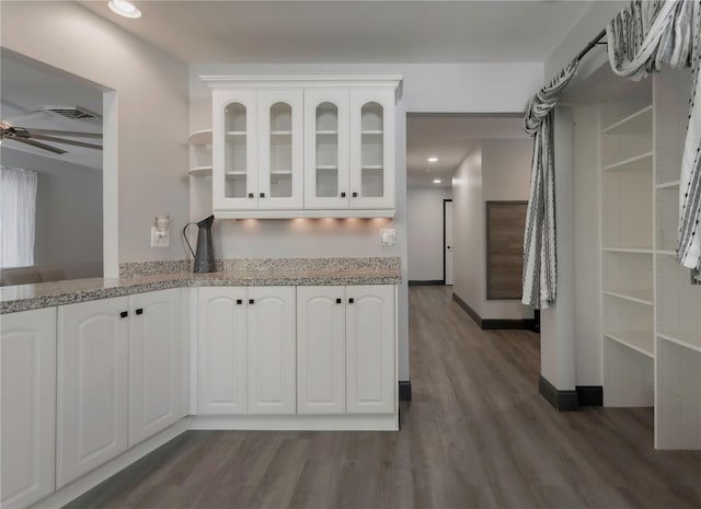 kitchen with white cabinetry, dark hardwood / wood-style flooring, and ceiling fan