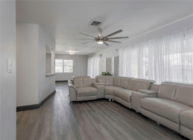 living room featuring ceiling fan and hardwood / wood-style flooring