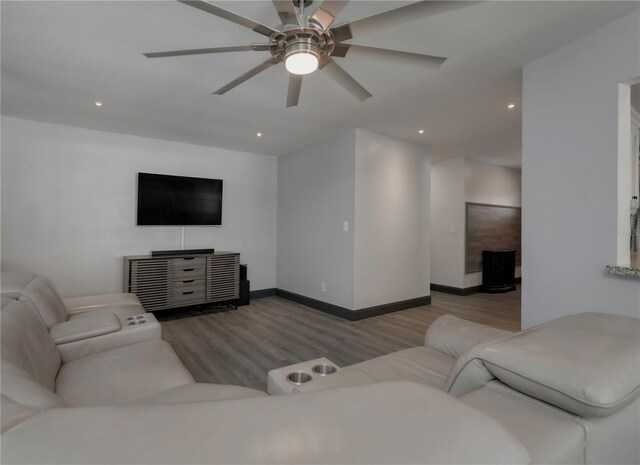 living room featuring light wood-type flooring and ceiling fan