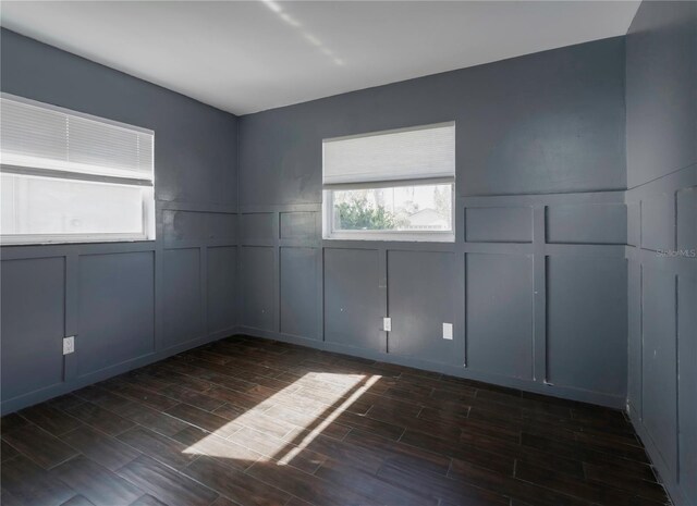 unfurnished room with dark hardwood / wood-style flooring