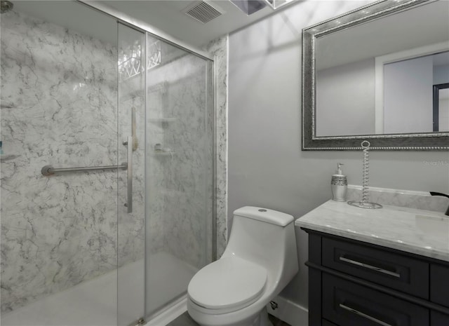 bathroom with vanity, a shower with shower door, and toilet