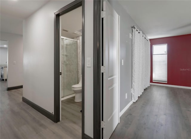 hallway with wood-type flooring