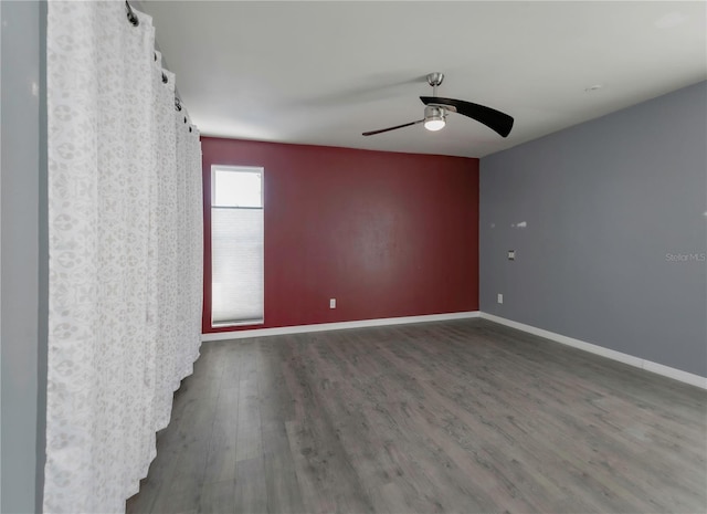 spare room with dark hardwood / wood-style floors and ceiling fan