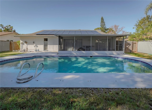 view of swimming pool featuring a sunroom