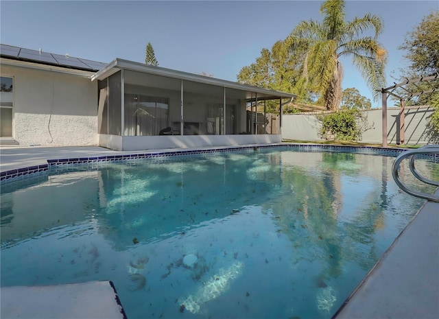 view of swimming pool with a sunroom