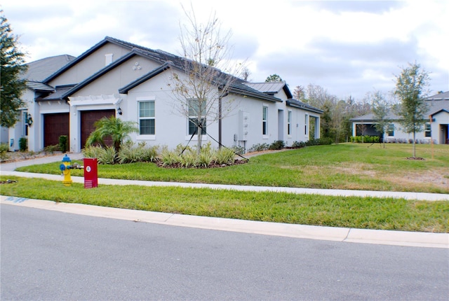 view of front of property with a garage and a front lawn