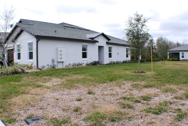 rear view of house with a yard