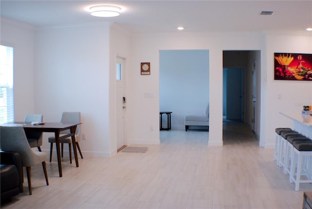 dining room featuring crown molding