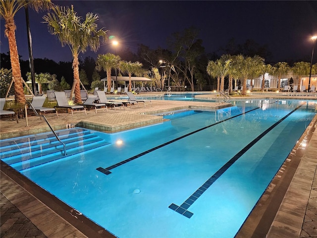 pool at night with a patio