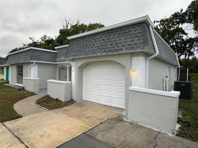 view of home's exterior featuring a garage and cooling unit