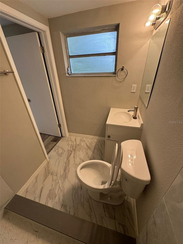 bathroom with vanity, toilet, and tile walls