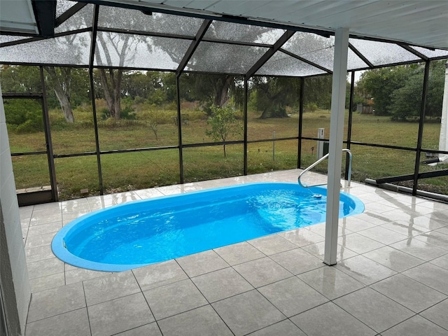 view of swimming pool with glass enclosure, a yard, and a patio