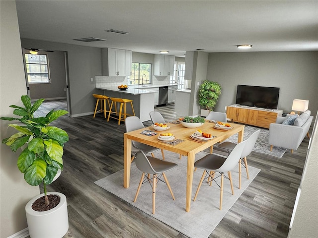 3349 Overland Dr, Holiday, FL 34691 - dining room featuring baseboards and dark wood-style floors