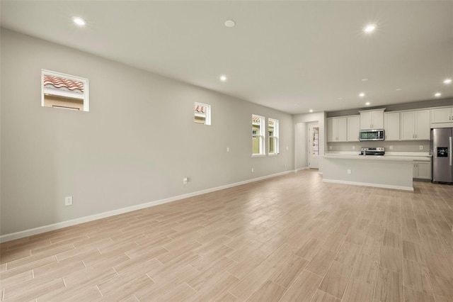 unfurnished living room with light hardwood / wood-style flooring