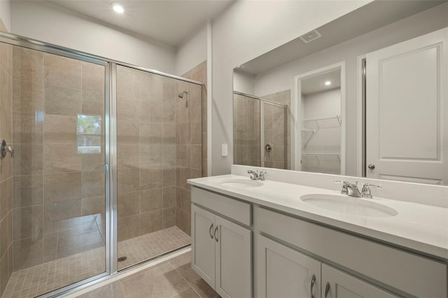 bathroom with walk in shower, tile patterned floors, and vanity