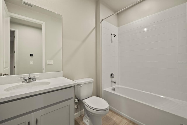 full bathroom featuring hardwood / wood-style flooring, vanity, shower / bathtub combination, and toilet