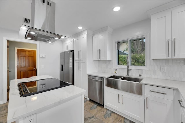 kitchen featuring sink, stainless steel appliances, backsplash, island exhaust hood, and white cabinets