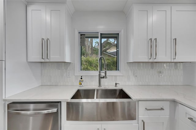 kitchen featuring stainless steel dishwasher, white cabinetry, and sink