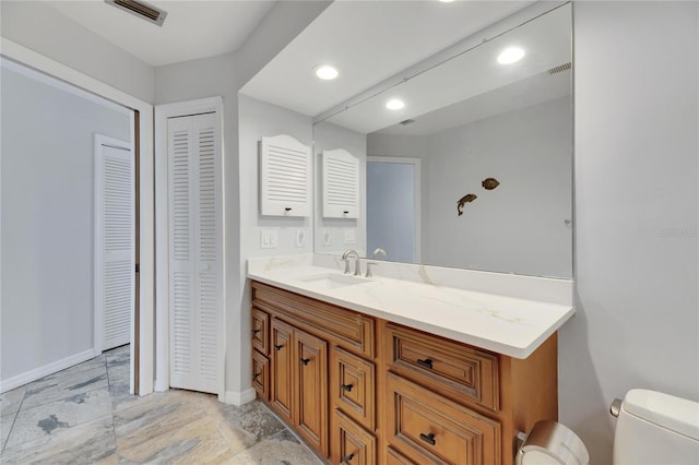 bathroom with vanity and toilet