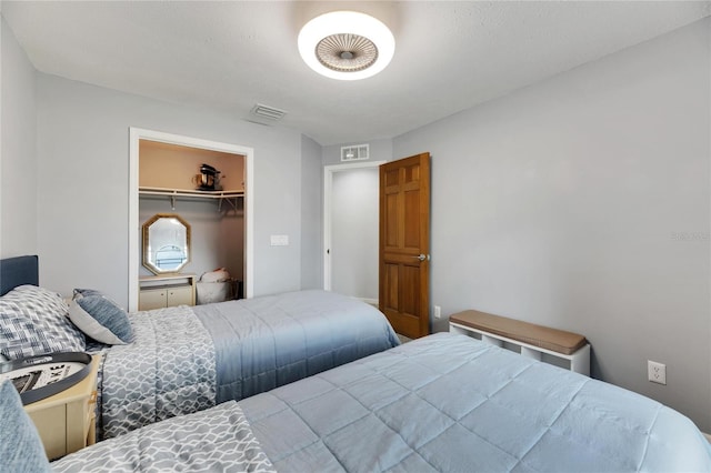 bedroom featuring a spacious closet and a closet