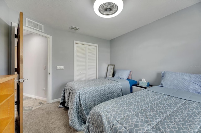 bedroom featuring light carpet and a closet