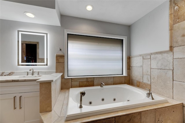 bathroom with tiled bath and vanity