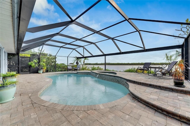 view of swimming pool featuring glass enclosure, a patio area, and an in ground hot tub