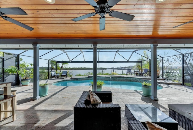 view of swimming pool featuring a patio area and a lanai