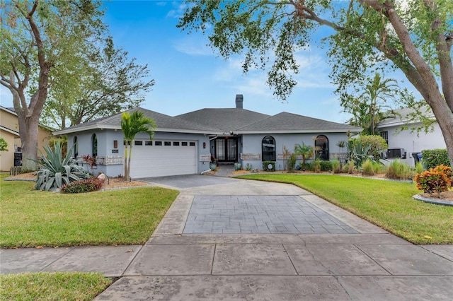 ranch-style home with a garage and a front lawn