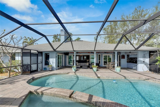 view of swimming pool with outdoor lounge area, a lanai, ceiling fan, and a patio area