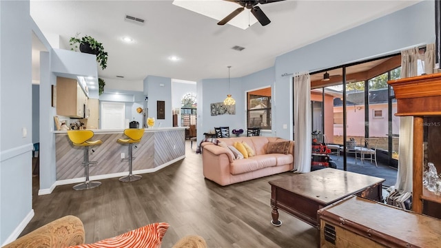 living room with dark hardwood / wood-style floors and ceiling fan