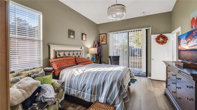 bedroom with light wood-type flooring and access to outside