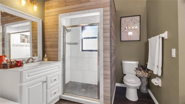 bathroom featuring wooden walls, toilet, a shower with shower door, and hardwood / wood-style flooring