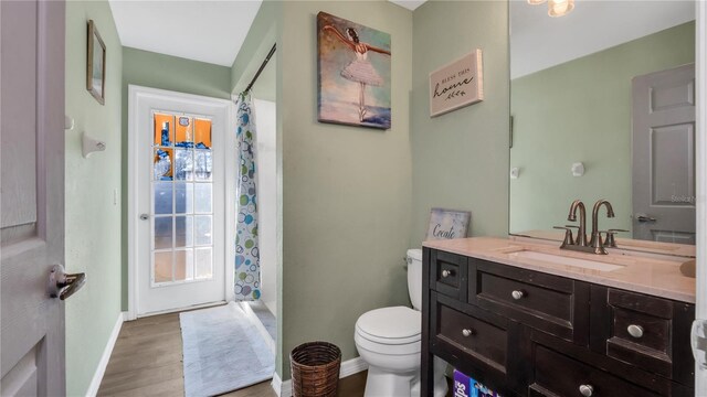 bathroom with vanity, toilet, wood-type flooring, and walk in shower