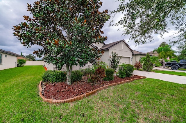 view of property exterior with a garage and a lawn