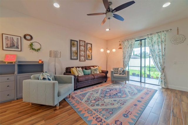 living room with ceiling fan and light hardwood / wood-style floors