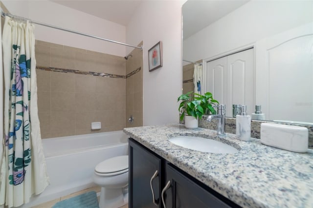 full bathroom featuring toilet, vanity, tile patterned floors, and shower / bath combo with shower curtain