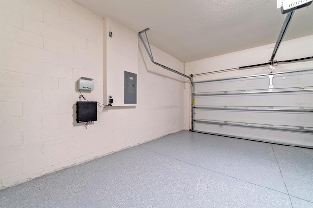 garage with electric panel and a garage door opener