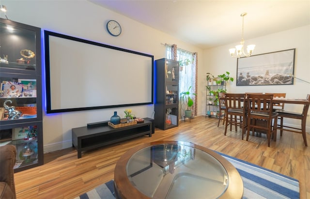 cinema with hardwood / wood-style floors and a chandelier