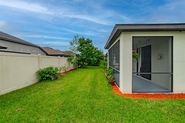 view of yard featuring a sunroom