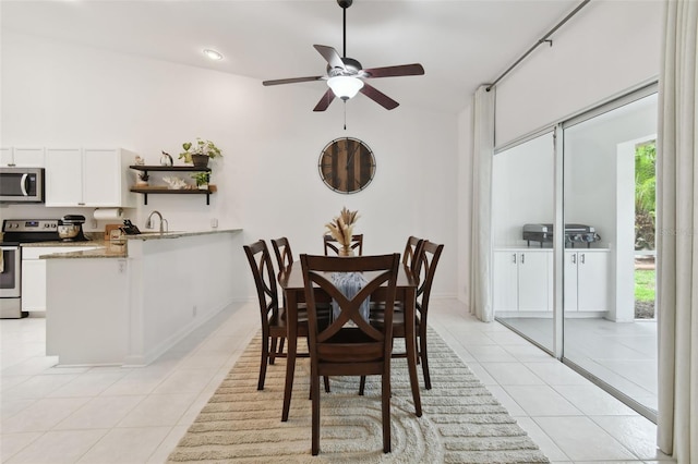 dining space with light tile patterned floors and ceiling fan