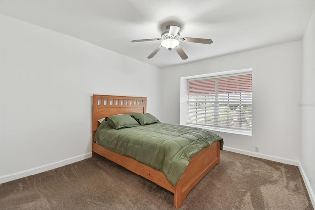 bedroom with baseboards, dark carpet, and ceiling fan